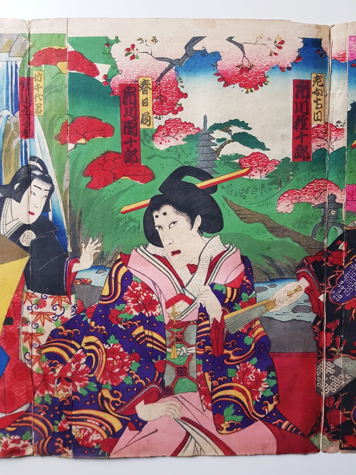 TOYOHARA KUNICHIKA (1835–1900) A Monumental Kabuki Ukiyo-e Triptych: A Scene of Dramatic Conflict beneath the blossoming trees, Japan, Meiji Period