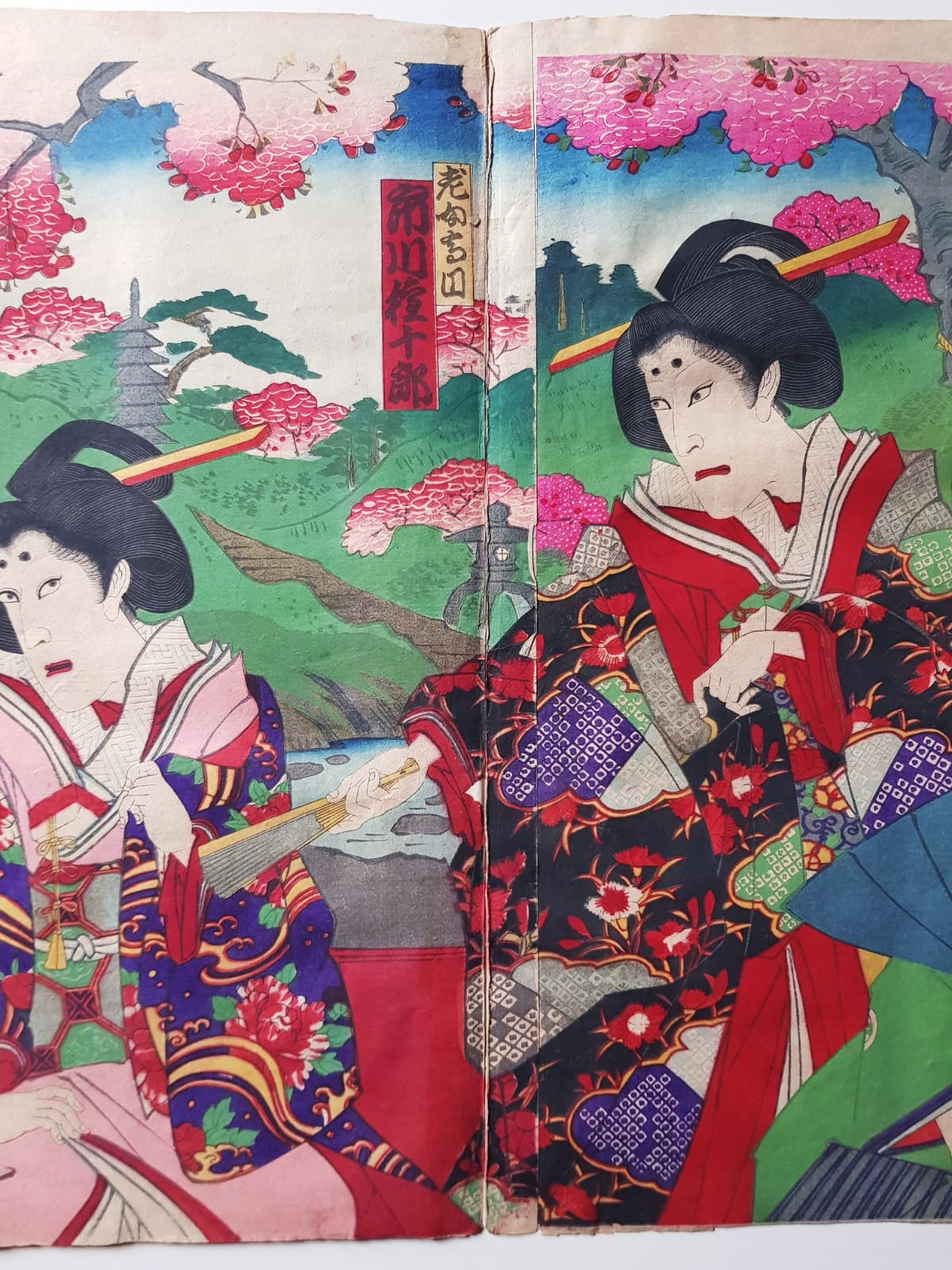 TOYOHARA KUNICHIKA (1835–1900) A Monumental Kabuki Ukiyo-e Triptych: A Scene of Dramatic Conflict beneath the blossoming trees, Japan, Meiji Period